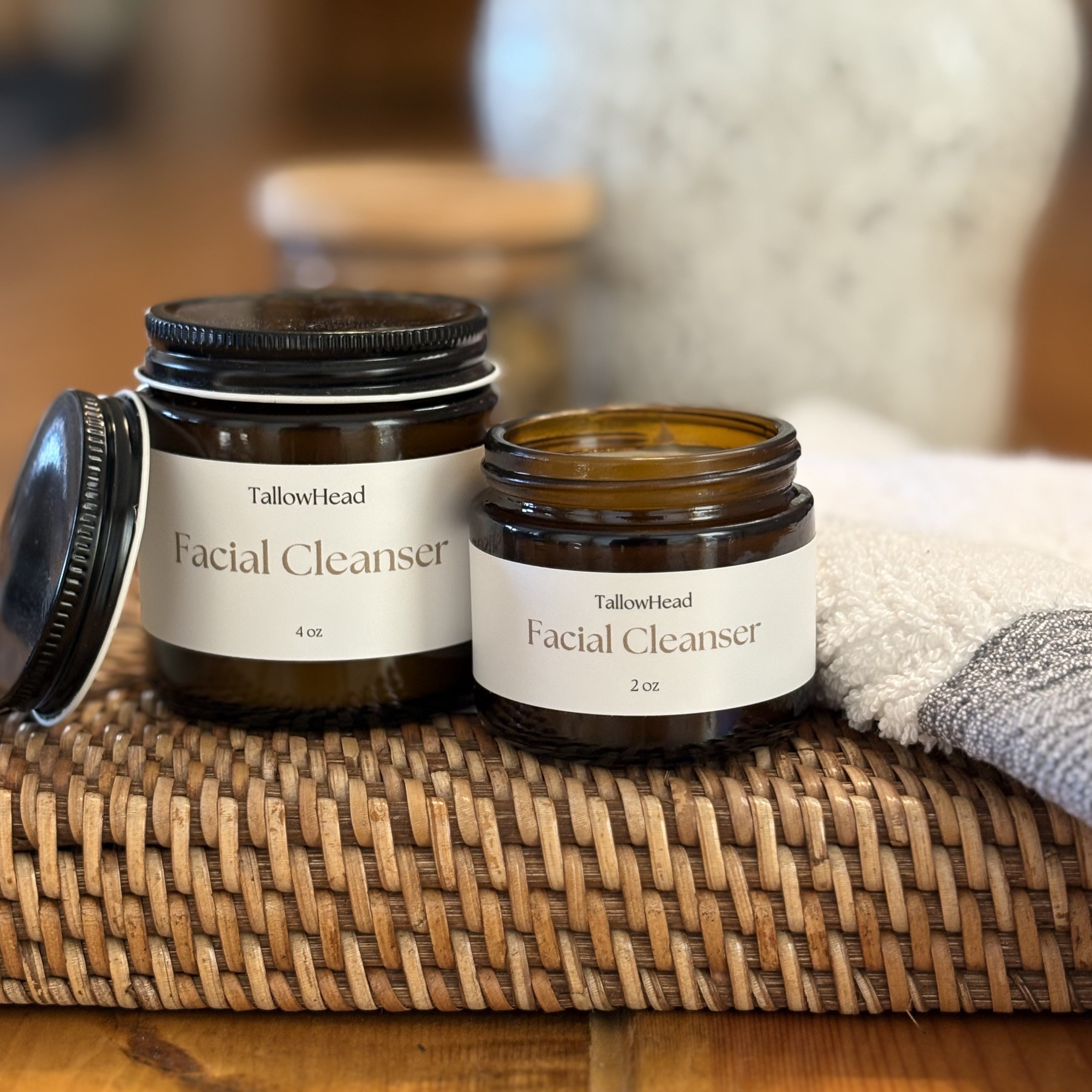 Two jars of Tallowhead Facial Cleanser on a woven mat with a blurred background